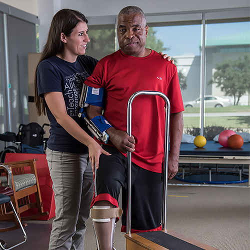 Stoke patient working with therapist in PT